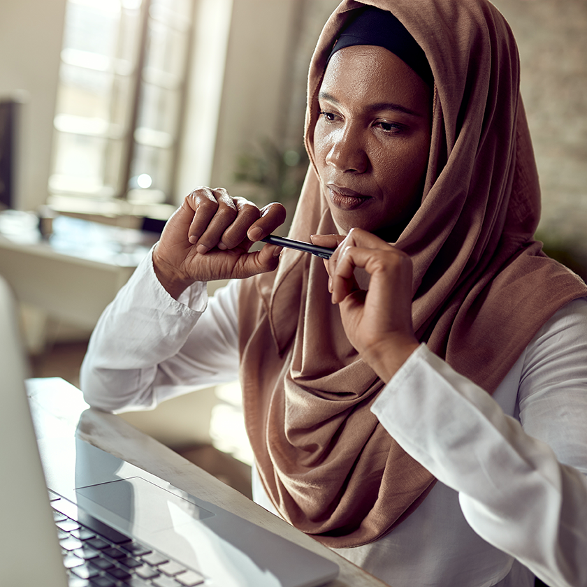 Thoughtful woman looking at her screen